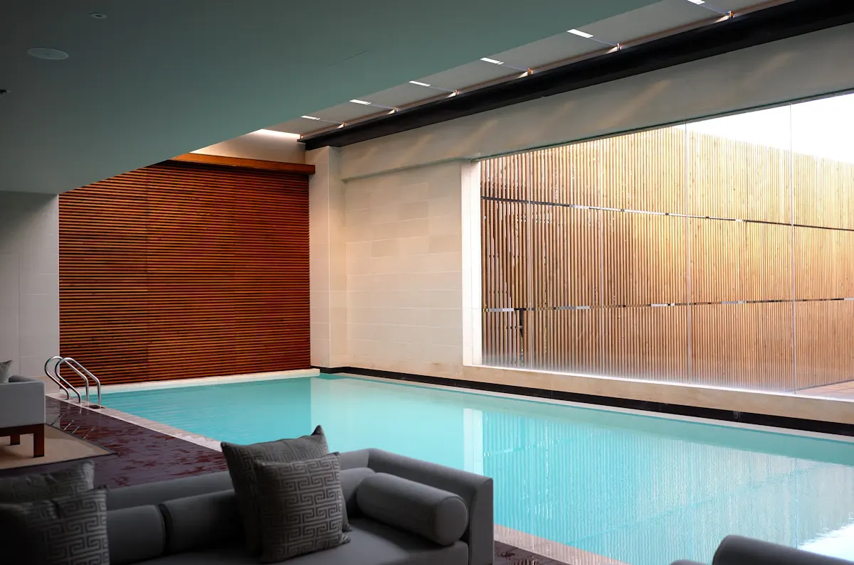 Indoor pool beside a timber-lined wall