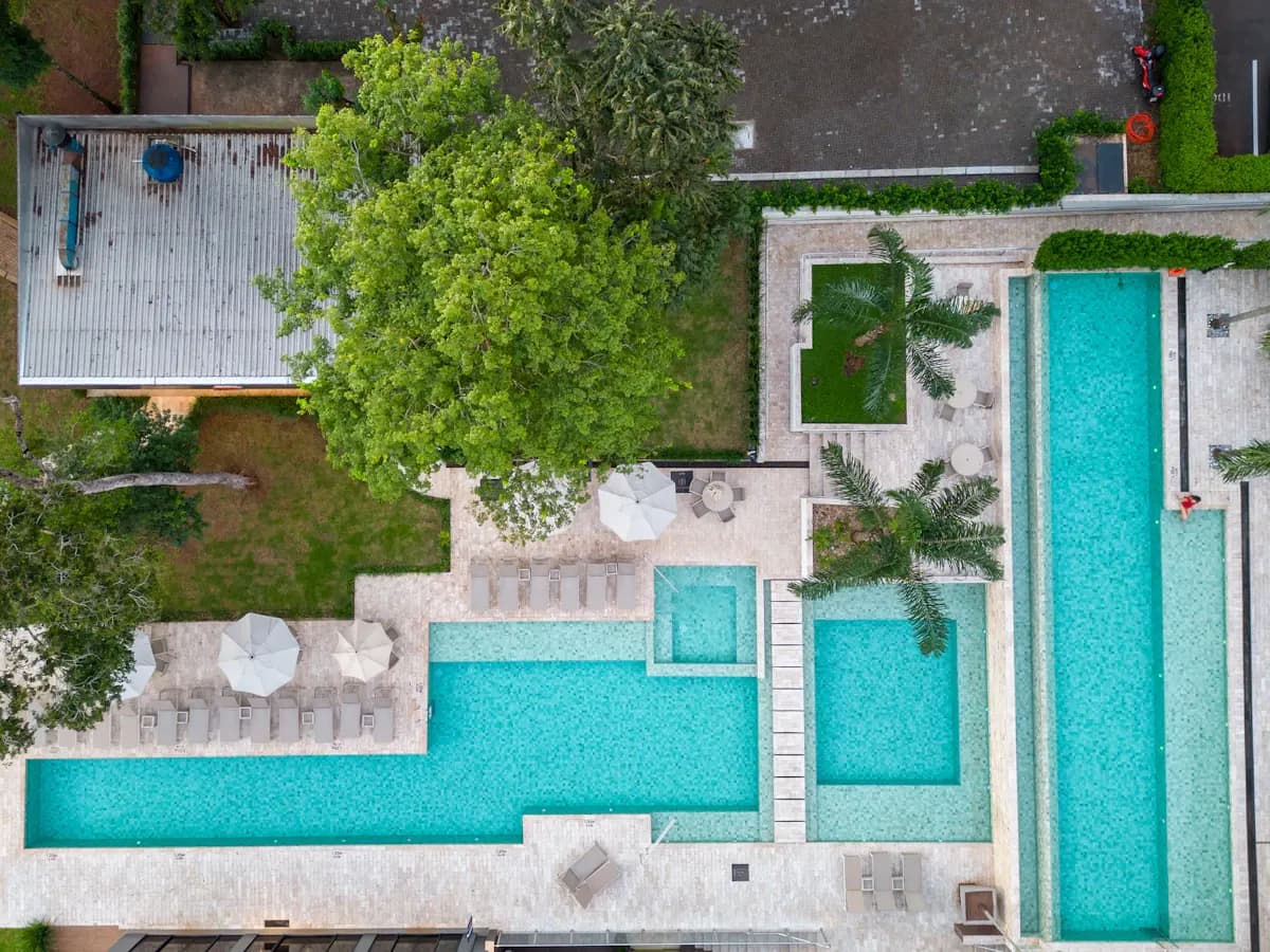 Overhead view of connected pools and surrounding garden paving