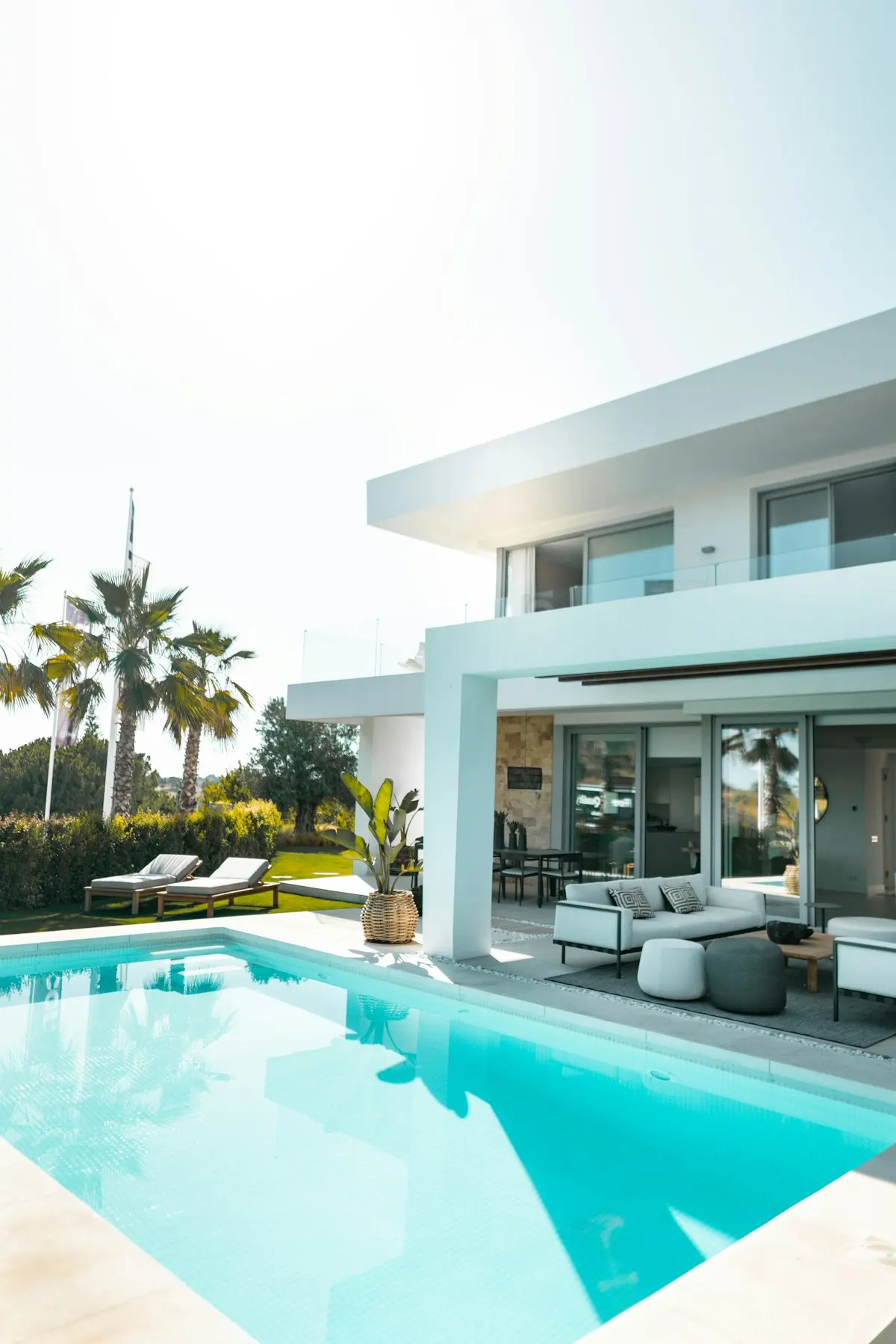 Swimming pool beside a modern house with a covered terrace